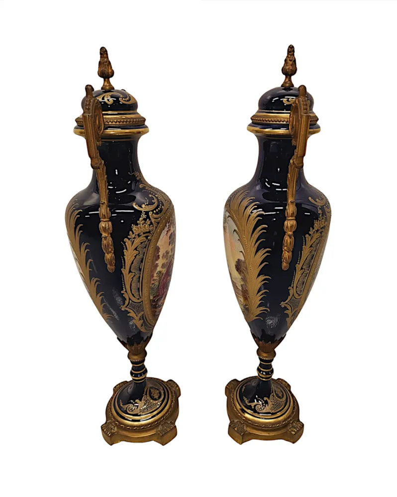 A Very Rare Pair of 19th Century French Hand Painted Sevres Style Urns with Ormolu Mounts
