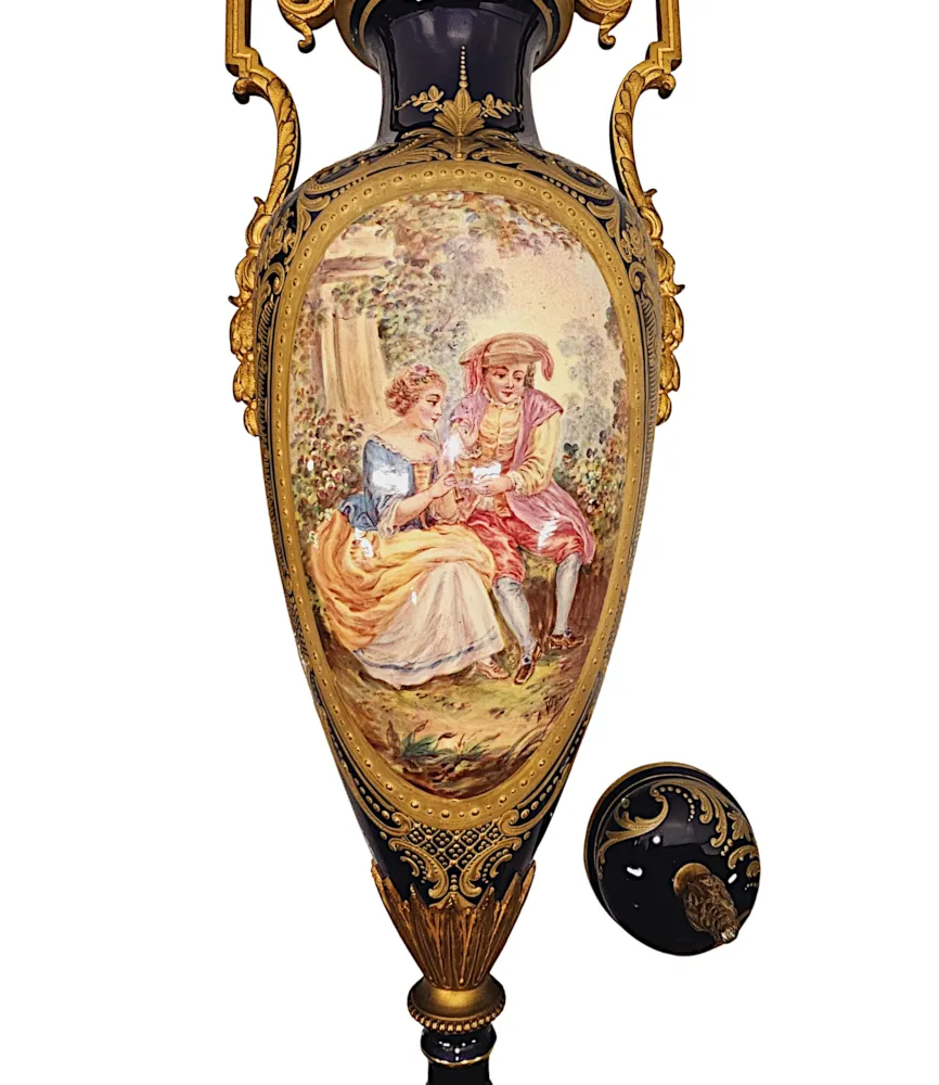 A Very Rare Pair of 19th Century French Hand Painted Sevres Style Urns with Ormolu Mounts