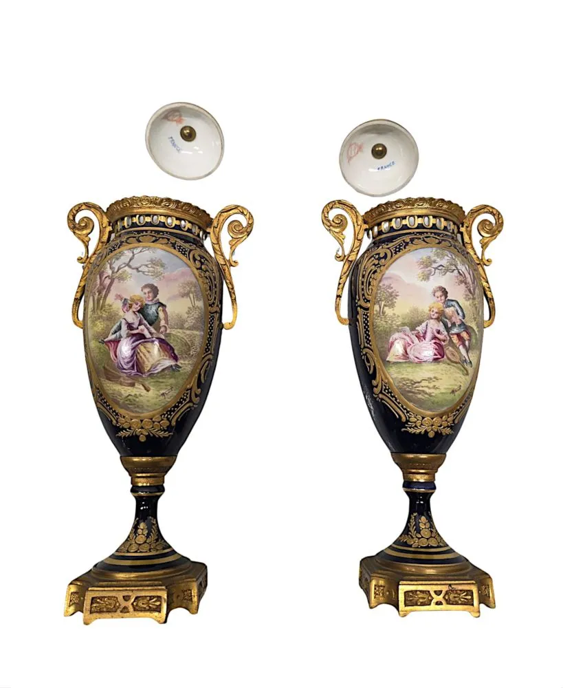  A Very Fine Pair of 19th Century Hand Painted Sevres Style Lidded Urns